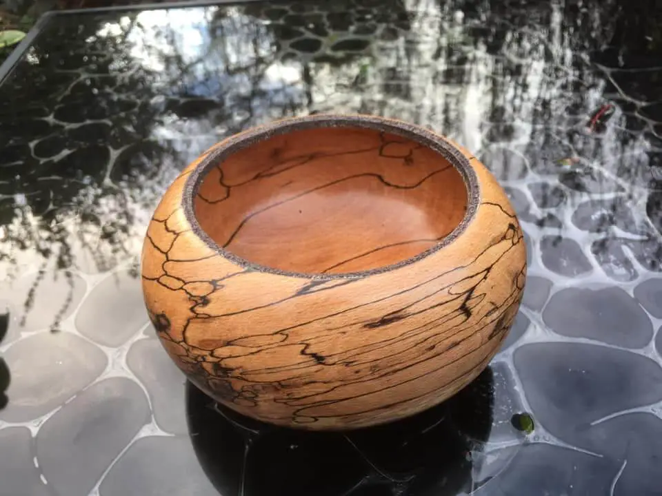 A spalted beech bowl with pyrographed rim