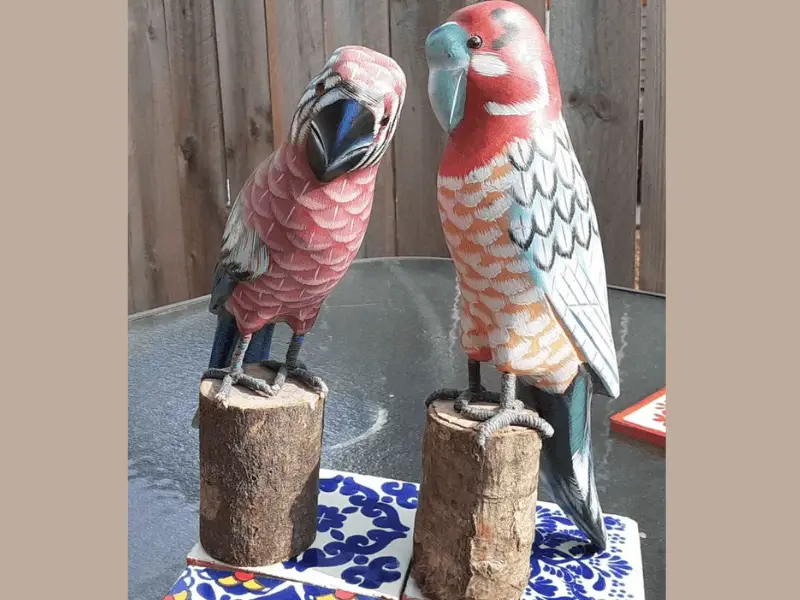 two balsa wood carved birds on tree stump