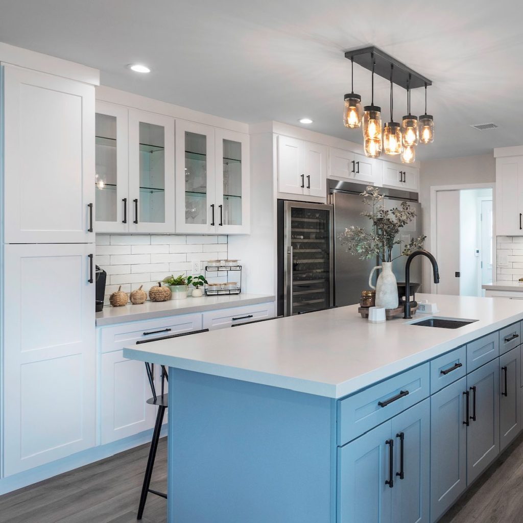 classic white cabinets with a bold blue island.