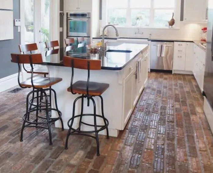 reclaimed brick running bond floor farmhouse kitchen with white island black counter stools
