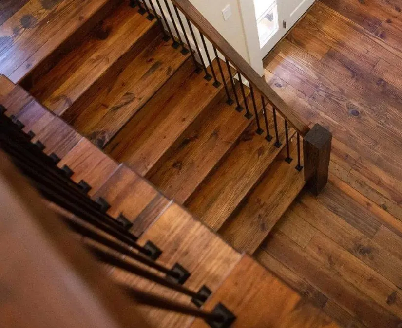 dark walnut stained hardwood flooring farmhouse staircase with iron railings and wide plank floors