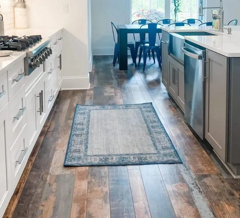 reclaimed dark mixed width wood flooring in modern farmhouse kitchen with gray and white cabinets