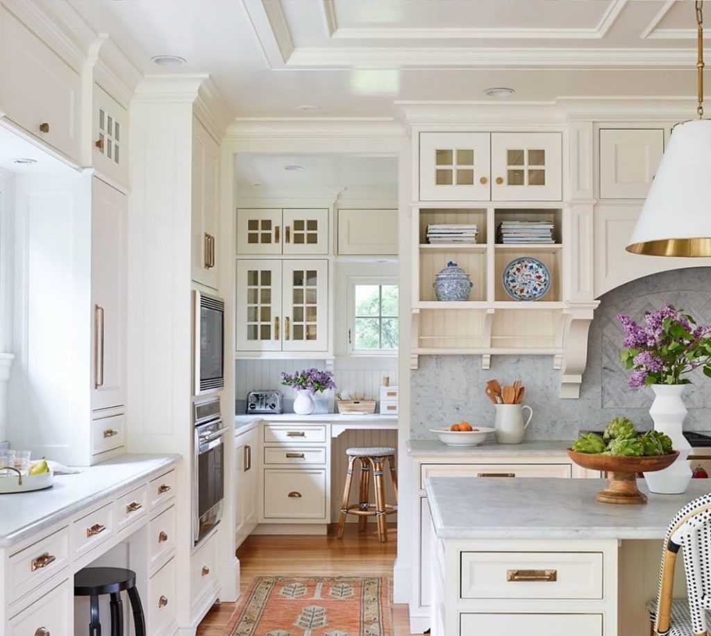 creamy white cabinets, adorned with brass hardware