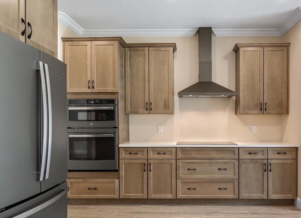 “River Run” stained maple shaker cabinets paired with black stainless steel appliances! 